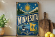 A vintage-style sign for Minnesota, featuring a sun, pine trees, and a duck, is displayed on a shelf next to a wooden cutting board and some lemons.