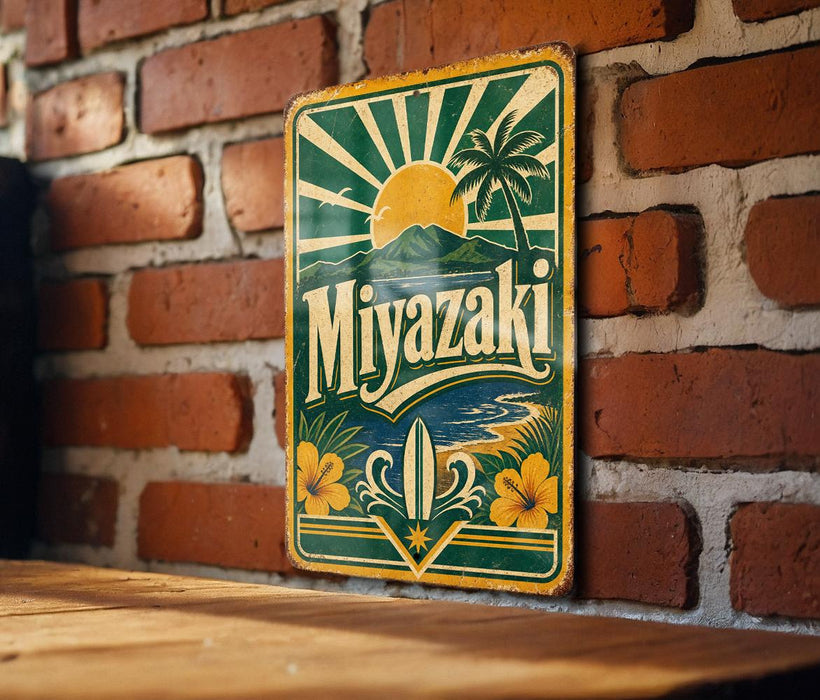 A vintage-style metal sign with a tropical beach scene and the word "Miyazaki" displayed on it, mounted on a brick wall.