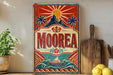 a vintage-style sign with a colorful design, including a sun, palm trees, and a sailboat, mounted on a wall.