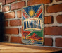 a vintage Namibia poster or sign hanging on a brick wall.