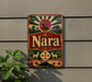 A vintage-style sign with the word "Nara" displayed prominently, featuring a deer, sun, and other traditional Japanese imagery.