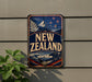 a vintage-style sign that reads "NEW ZEALAND" with a kiwi bird and mountain landscape.