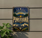 A vintage-style sign for Pennsylvania, featuring a sunburst design with mountains, trees, and a city skyline.