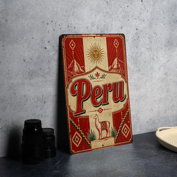 a vintage-style metal sign with the word "Peru" prominently displayed, along with a decorative border and a sun motif. The sign is placed on a gray countertop, and there are some black camera lenses visible in the background.