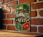 A vintage-style sign with the text "SAINT KITTIS AND NEVIS" displayed on a brick wall.