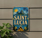A vintage-style sign with the text "SAINT LUCIA" displayed prominently, featuring a tropical landscape with palm trees, mountains, and a sun.