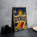 A vintage-style metal sign with the word "SEYCHELLES" prominently displayed, featuring a tropical landscape with palm trees, a sun, and a hibiscus flower.