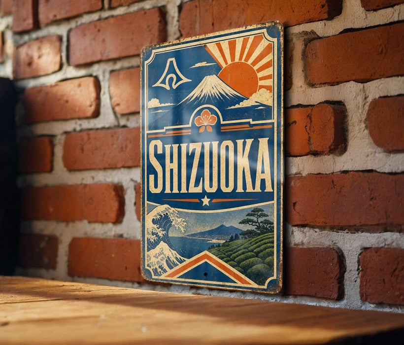 A vintage-style sign for Shizuka, a city in Japan, is displayed on a brick wall.