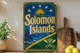 A vintage-style sign for the Solomon Islands, featuring a blue background with a sun and palm trees, and the text "Solomon Islands" prominently displayed.