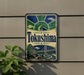 A vintage-style sign for "Tokushima" is displayed on a wall, featuring a bridge and ocean scene.