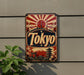 A vintage-style metal sign with the word "Tokyo" prominently displayed, featuring a sun and Japanese-style architecture.