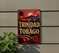 A decorative sign with the text "TRINIDAD AND TOBAGO" against a tropical background, featuring palm trees, a sunset, and a hibiscus flower.