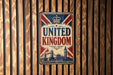 A vintage-style sign that reads "UNITED KINGDOM" is displayed against a wooden background.
