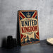 A vintage-style metal sign with the text "UNITED KINGDOM" prominently displayed, featuring a British flag design and a crown. The sign is placed on a gray countertop, with a stack of black camera lenses and a white dish visible to the side.