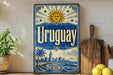 A vintage-style sign for Uruguay, featuring a sun and palm trees, is displayed on a shelf next to a wooden cutting board and some lemons.
