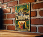 A vintage Zimbabwe sign is displayed on a brick wall, featuring a colorful illustration of the country's landscape and wildlife.