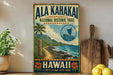 A vintage-style sign for the Ala Kahaki National Historic Trail in Hawaii, featuring a tropical beach scene with palm trees, mountains, and a sailboat.