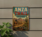 a vintage-style metal sign with a cowboy on horseback, advertising the Anza Trail in Arizona.