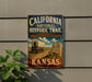 A vintage-style sign for the California National Historic Trail, featuring an illustration of a covered wagon and a monument, mounted on a wall.