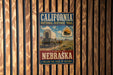 A vintage-style metal sign for the California National Historic Trail in Nebraska, featuring an illustration of a covered wagon and the text "Follow the Trail of History".