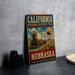 A vintage-style metal sign for the California National Historic Trail in Nebraska, featuring an illustration of a covered wagon and the text "Follow the Trail of History" and "Nebraska".
