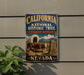 A vintage-style metal sign for the California National Historic Trail in Nevada, featuring an illustration of a covered wagon and a sign that says "California National Historic Trail" and " Nevada".