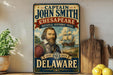 A vintage-style sign featuring a portrait of a bearded man, with text indicating that he is Captain John Smith from the Chesapeake National Historic Trail in Delaware.