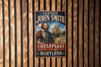 A vintage metal sign featuring a portrait of a man with a beard, mounted on a wooden wall.