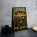 a vintage-style metal sign with a colorful illustration of a group of people on a trail, along with text that reads "CHEROKEE TRAIL OF TEARS A HISTORIC JOURNEY A LASTING LEGACY OOKAHOMA HONORING THE CHEROKEE PEOPLE AND THEIR STRENGTH".