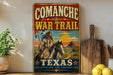 a vintage-style sign with a Native American figure riding a horse, set against a desert landscape with mountains in the background. The sign is titled "COMANCHE WAR TRAIL TEXAS" and includes the phrase "FOLLOW THE LEGEND" at the bottom.