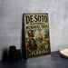 A vintage metal sign for the De Soto National Memorial Trail in Florida, featuring an illustration of a man in historical attire and a sailing ship.