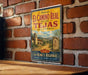 A vintage-style sign for the historic El Camino Real in Tejas, California, featuring a scenic illustration of a historic road and buildings.