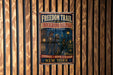 A vintage-style sign for the "Freedom Trail of the Underground Railroad" is displayed on a wooden wall.