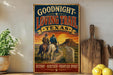 A vintage-style metal sign with a cowboy illustration and the text "Goodnight Loving Trail Texas" is displayed on a shelf next to a wooden cutting board and some lemons.