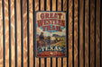 A vintage-style metal sign with the text "GREAT WESTERN TRAIL TEXAS" is displayed on a wooden wall.