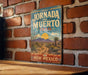 A vintage-style metal sign with the text "JORNADA DEL MUEURTO TRAIL" is displayed on a brick wall, indicating a historic path through New Mexico.