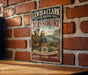A vintage metal sign for the Lewis & Clark National Historic Trail in Missouri, featuring an illustration of two men and a map, mounted on a brick wall.