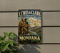 A vintage metal sign for the Lewis & Clark National Historic Trail in Montana, featuring two men on a journey along the trail.