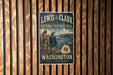 A vintage-style metal sign for the Lewis and Clark National Historic Trail in Washington, featuring an illustration of two men in historical attire and a scenic landscape.