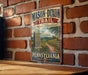 A vintage-style metal sign for the Mason-Dixon Trail in Pennsylvania, featuring a scenic illustration of a trail and a monument.