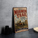 A vintage-style metal sign for the "Historic Mormon Trail Iowa" with an illustration of a wagon train and a sign that says "Faith + Courage + Pioneer Spirit".