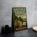 A vintage-style metal sign for the Natchez Trace National Historic Trail, featuring a scenic illustration of a trail, a monument, and a flower.