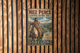 A vintage metal sign for Nez Perce National Historic Trail, featuring an illustration of a Native American man riding a horse.