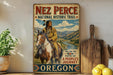 a vintage-style poster of a Native American man riding a horse, with the text "NEZ PERCE NATIONAL HISTORIC TRAIL" and "FOLLOW THE PATH OF A PEOPLE'S JOURNEY OREGON" displayed prominently.