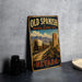 a vintage-style metal sign with the text "Old Spanish National Historic Trail Nevada" and an illustration of a wagon train on a dirt road.