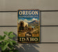A vintage-style metal sign for the Oregon National Historic Trail, featuring a wagon traveling through a scenic landscape with mountains in the background.