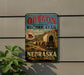 a vintage-style sign for the Oregon National Historic Trail, depicting a wagon train traveling through a scenic landscape.