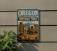 a vintage-style sign for the Oregon National Historic Trail, depicting a wagon train traveling through a scenic landscape with mountains in the background.