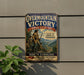 a vintage metal sign with a historical theme, mounted on a wall next to a plant.