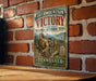 A vintage-style metal sign for the Overmountain Victory National Historic Trail in Tennessee, featuring a historical illustration of a group of people on a trail.